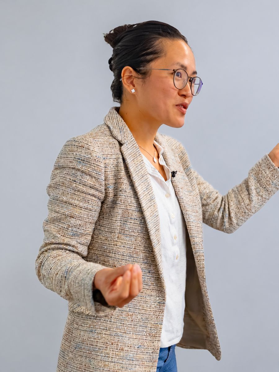 Orbiss team member in a tweed blazer and glasses, speaking to the room