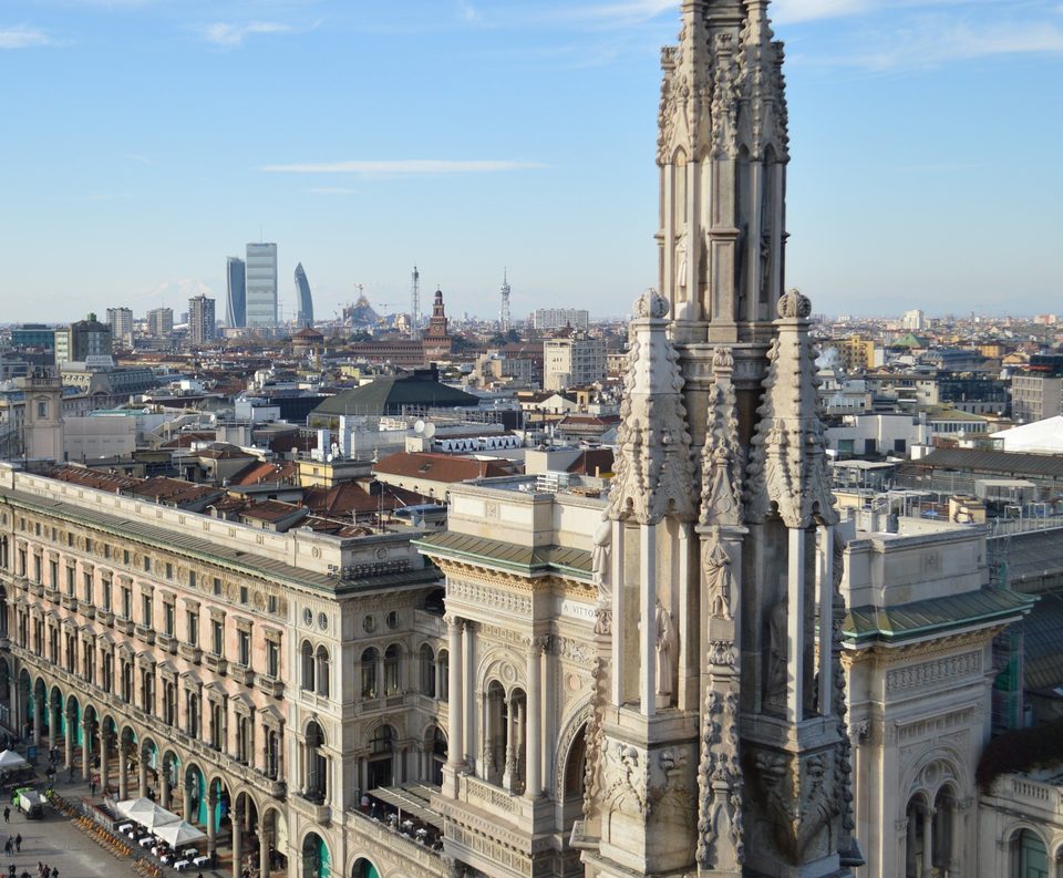 A spire of Milan Cathedral above the Galleria Vittorio Emanuele II and Piazza del Duomo