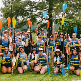 Orbiss team-building activity kayaking together for wellness and unity.